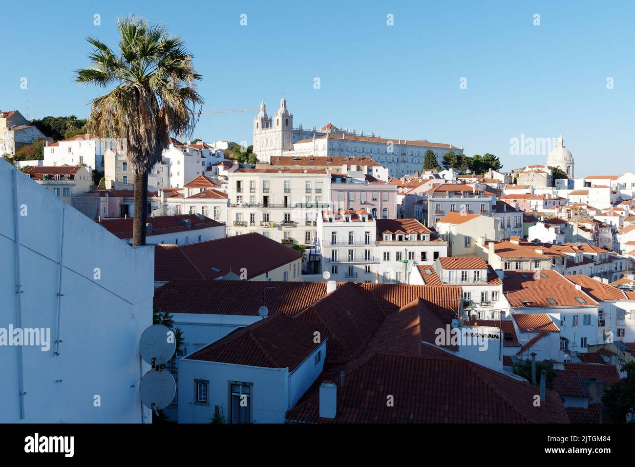 Viewpoint Miradouro Portas do Sol in Lisbon Portugal across the rooftops of the city on a summers evening with Monastery of São Vicente de Fora. Stock Photo
