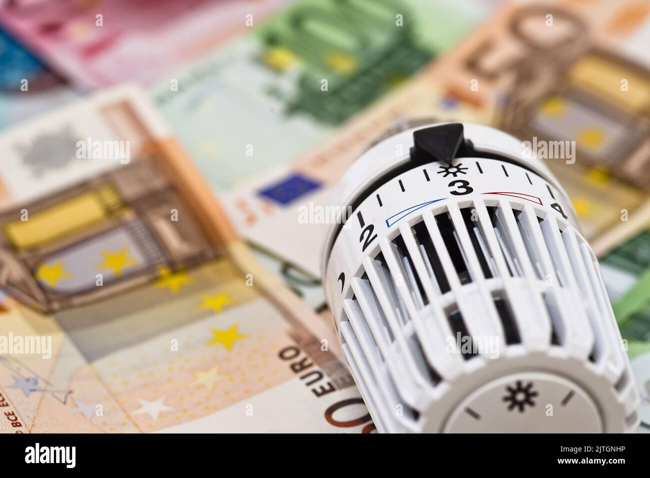 heating thermostat and banknotes, rising heating costs Stock Photo Alamy