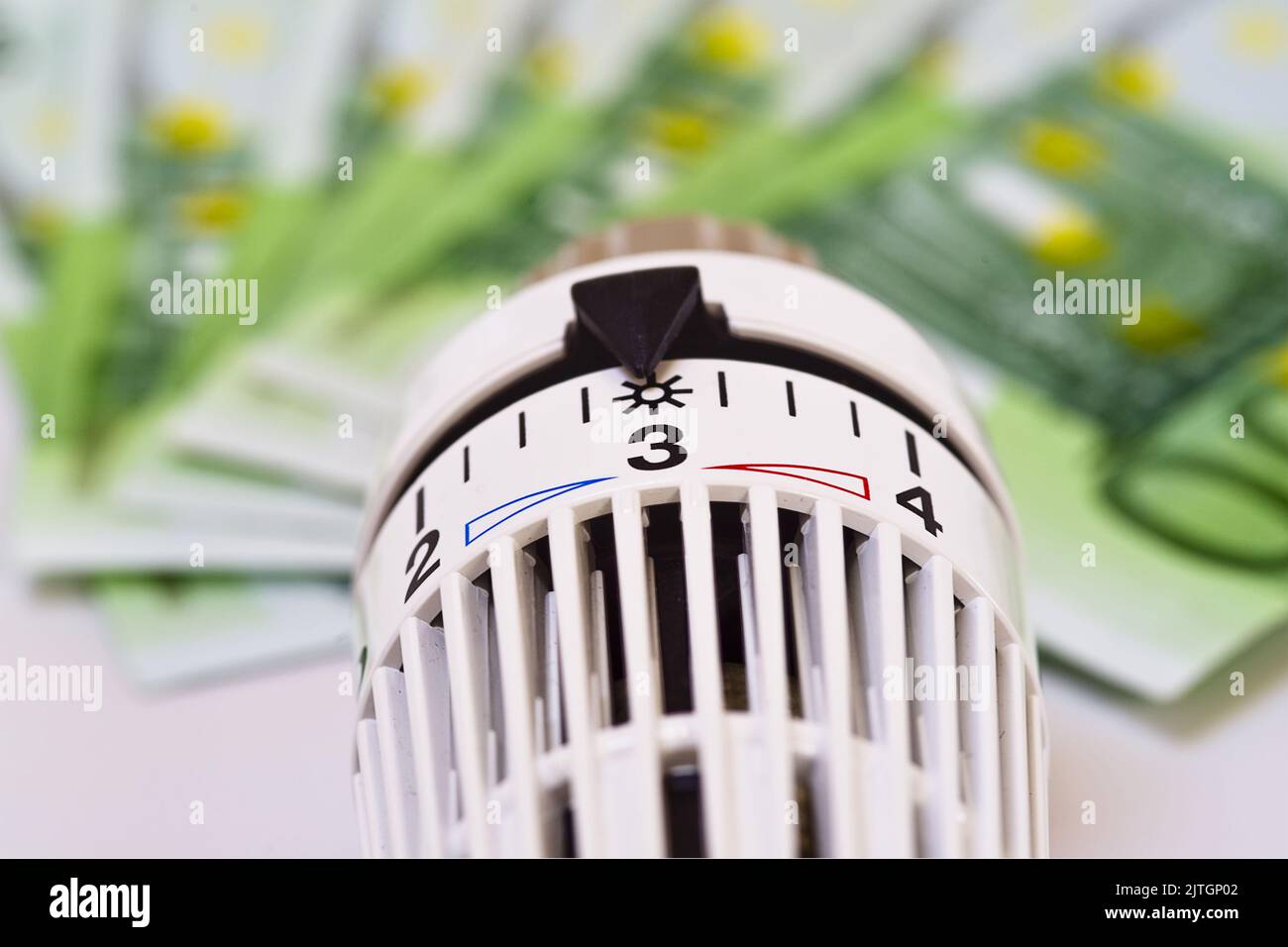 heating thermostat and banknotes, rising heating costs Stock Photo Alamy