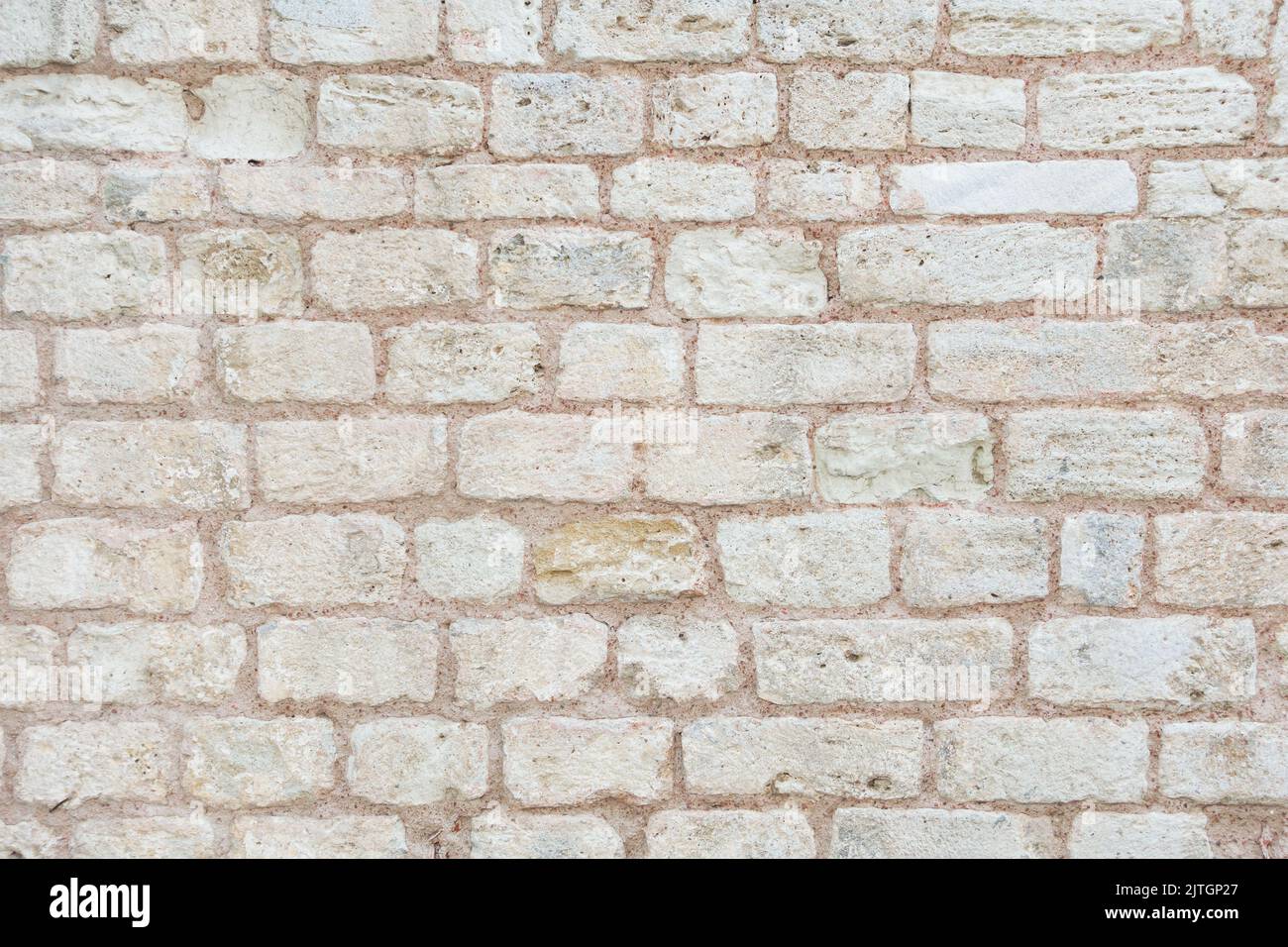 Photo of old brick wall. Beige background, texture of big brick wall. Stock Photo