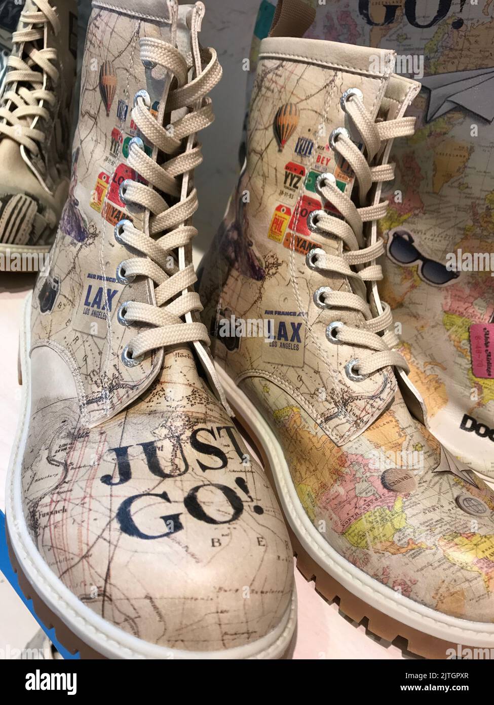 Ladies boots with travel map print and text Stock Photo