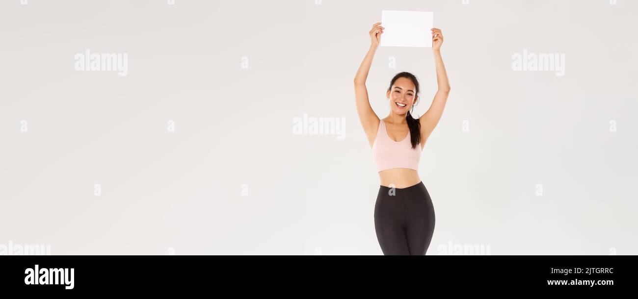 Full length of cheerful, slim and happy cute girl training in gym