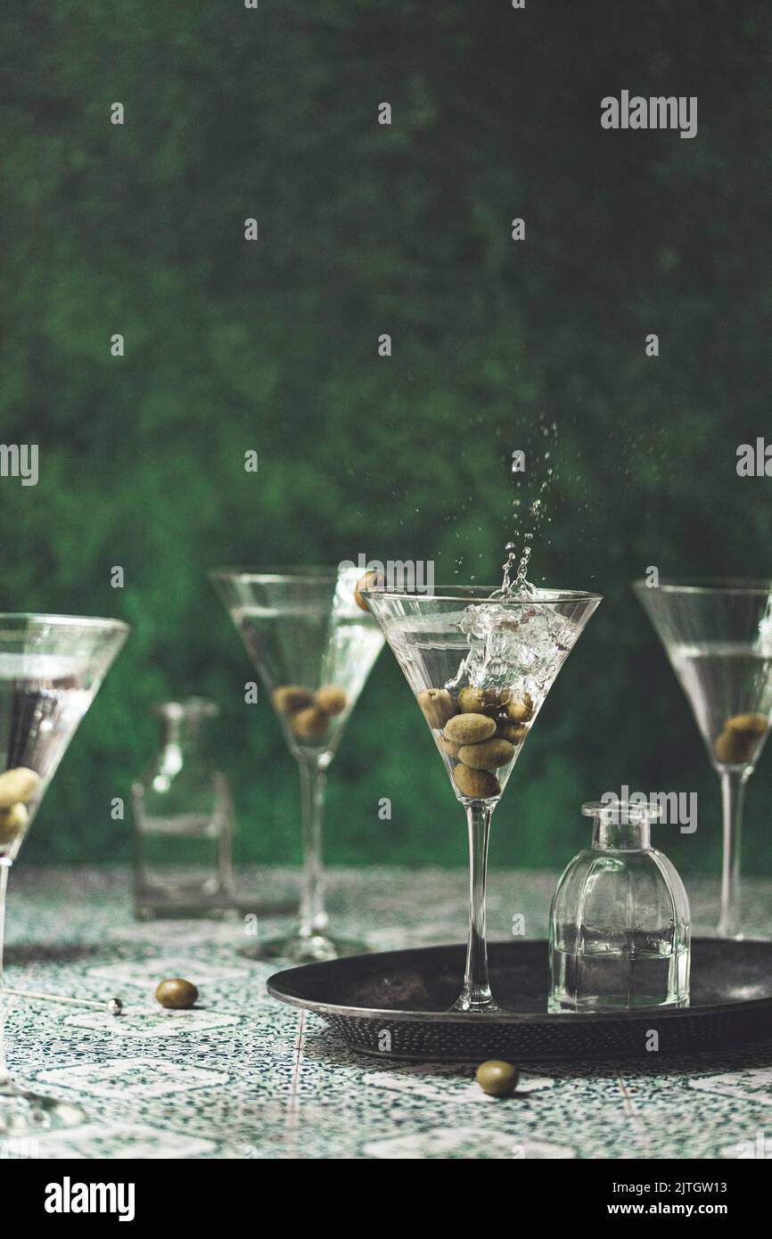 Martini with olives splashing in to a glass Stock Photo Alamy