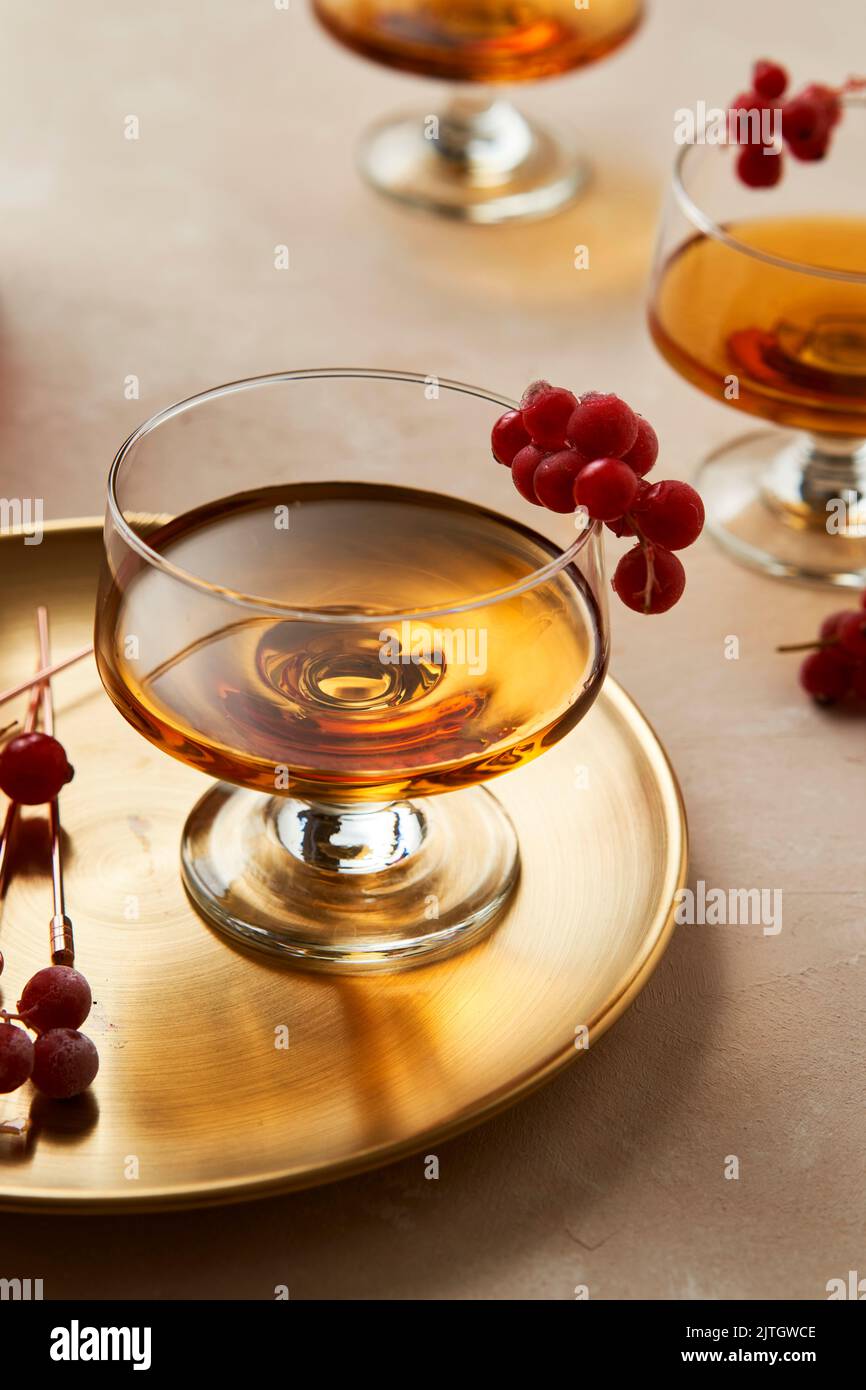 Rum in Glass with Redcurrants on Gold tray Stock Photo
