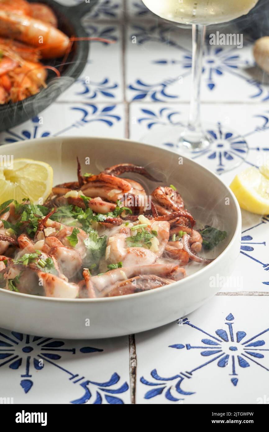 grilled squid with garlic and lemon juice, parsley, a glass of white