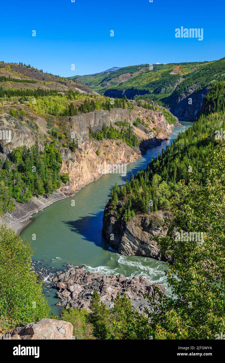 Exposed lava flows are visible along the west side of the Stikine River Stock Photo