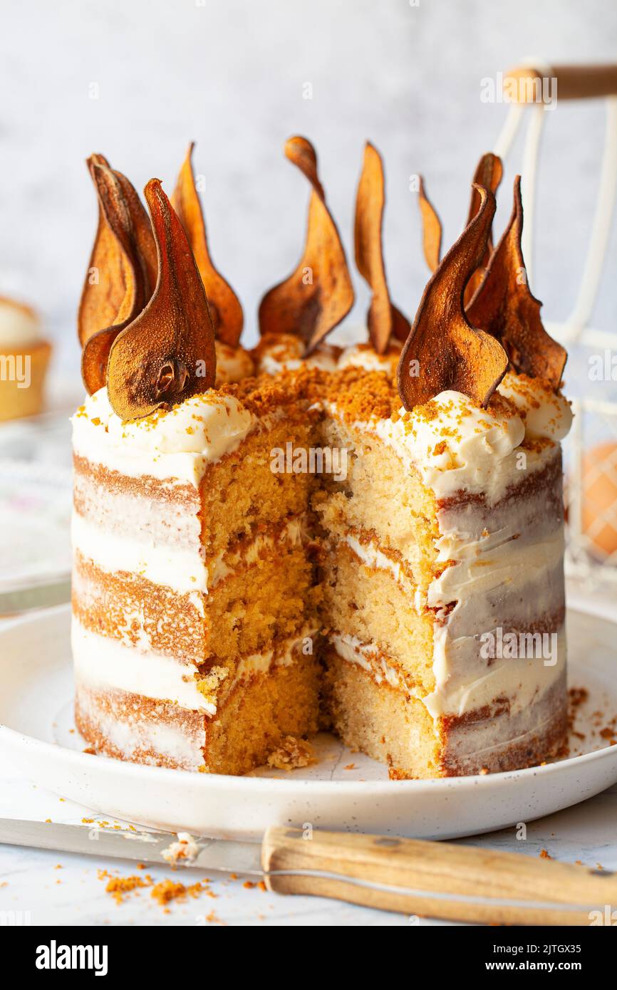 A layer cake decorated with buttercream frosting, cookie crumbs and