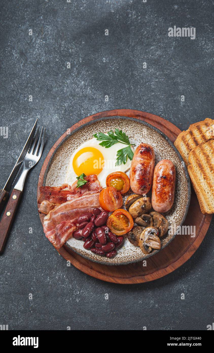 Traditional full English breakfast with fried eggs, sausages, beans