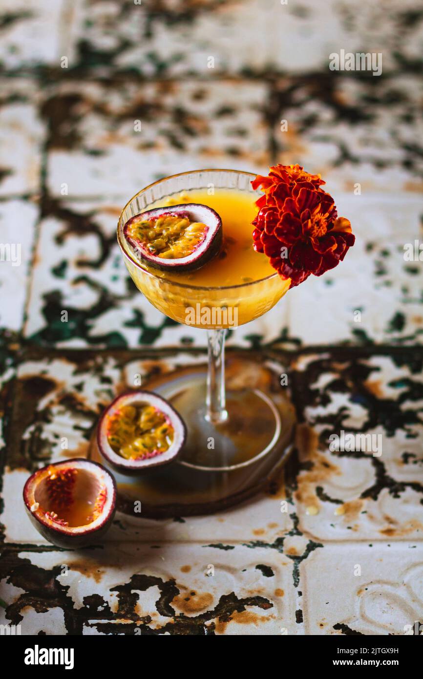 Passion fruit martini with French marigold Stock Photo Alamy