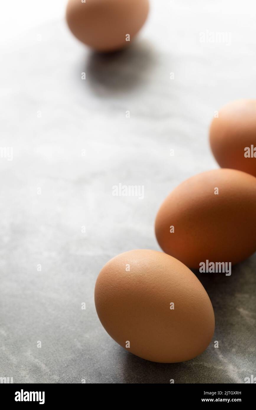 Chicken eggs scattered on light grey marble. Stock Photo