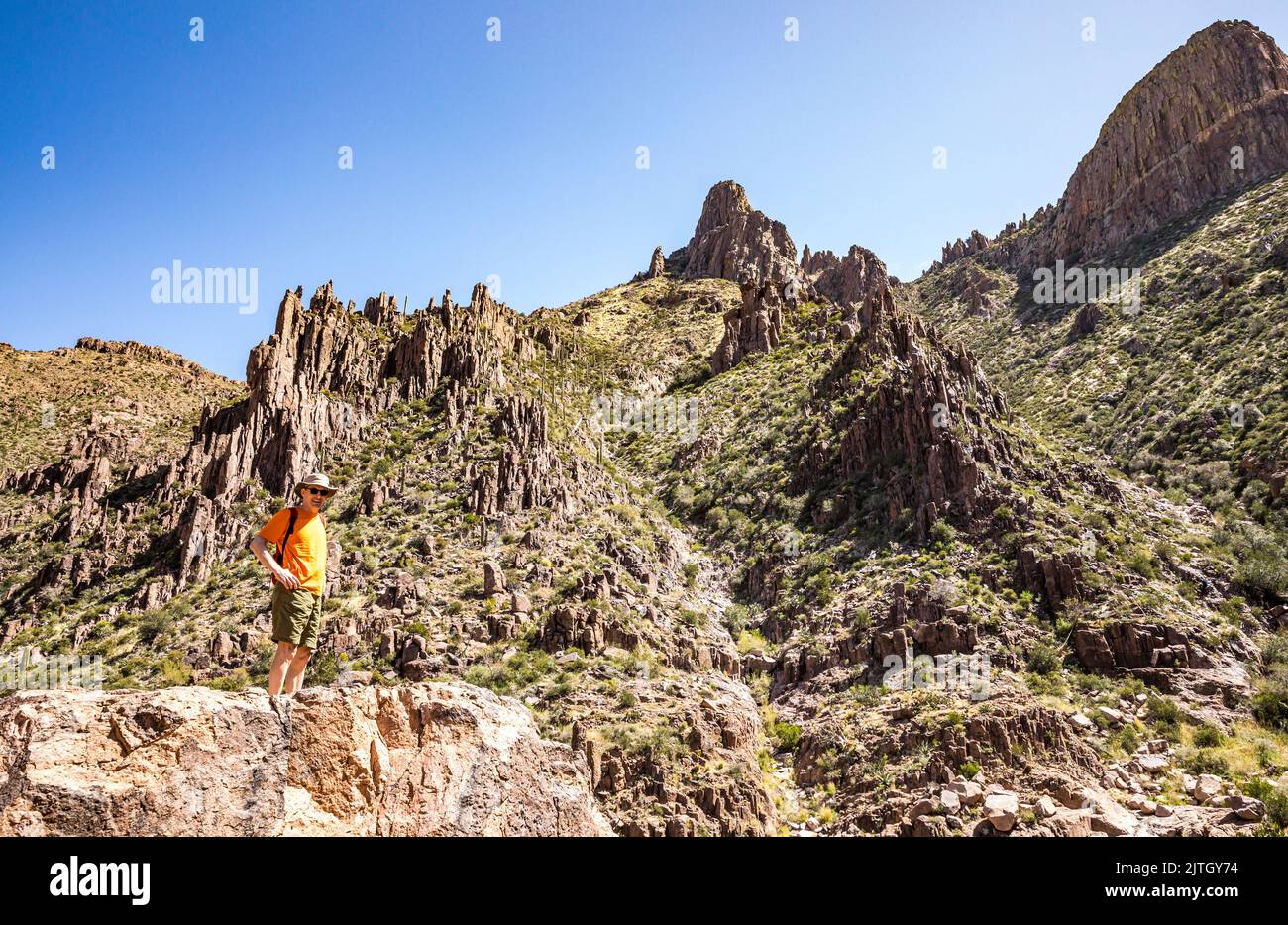A man posing for a picture on the Siphon Draw trail, Lost Dutchman State Park, Arizona. Stock Photo