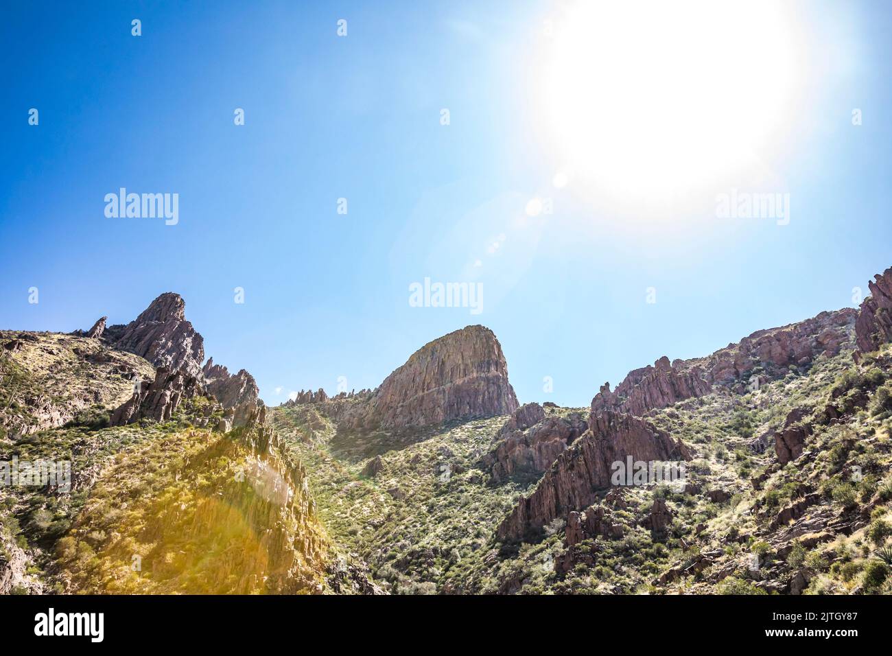 The landscape and sun flare near the top of the Siphon DRaw trail in Lost Dutchman State Park, Arizona. Stock Photo