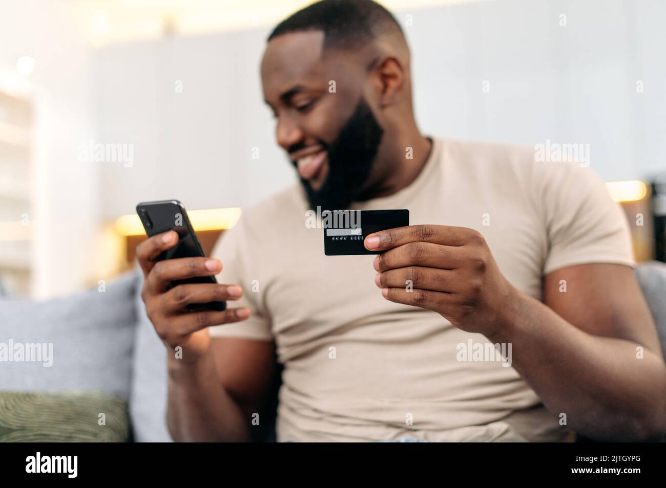 Online shopping, payment. Defocused african american man, sits on a