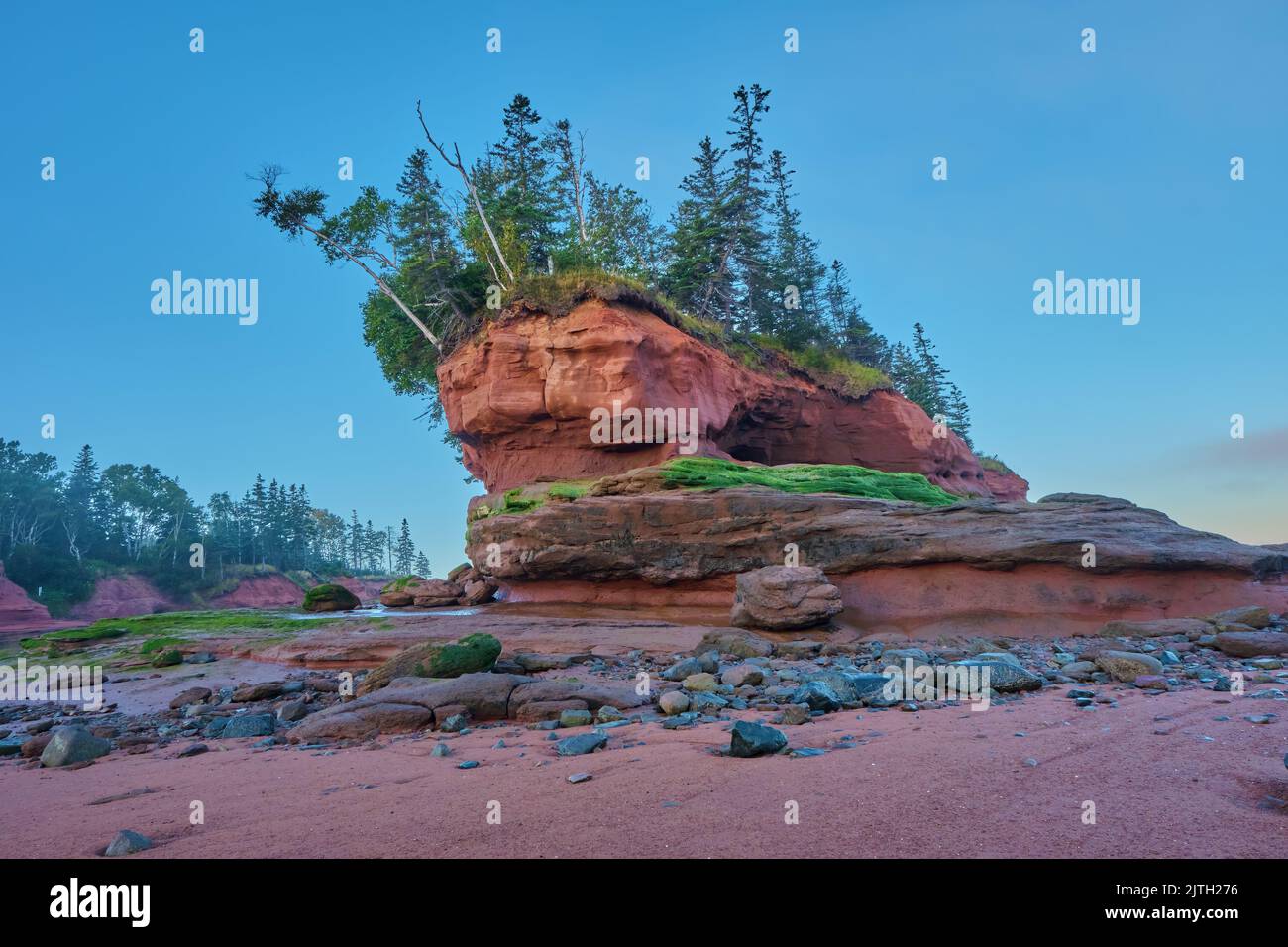 Sun Rising Stack Sea stack lit by the rising sun during low tide at Burntcoat Head Park ...