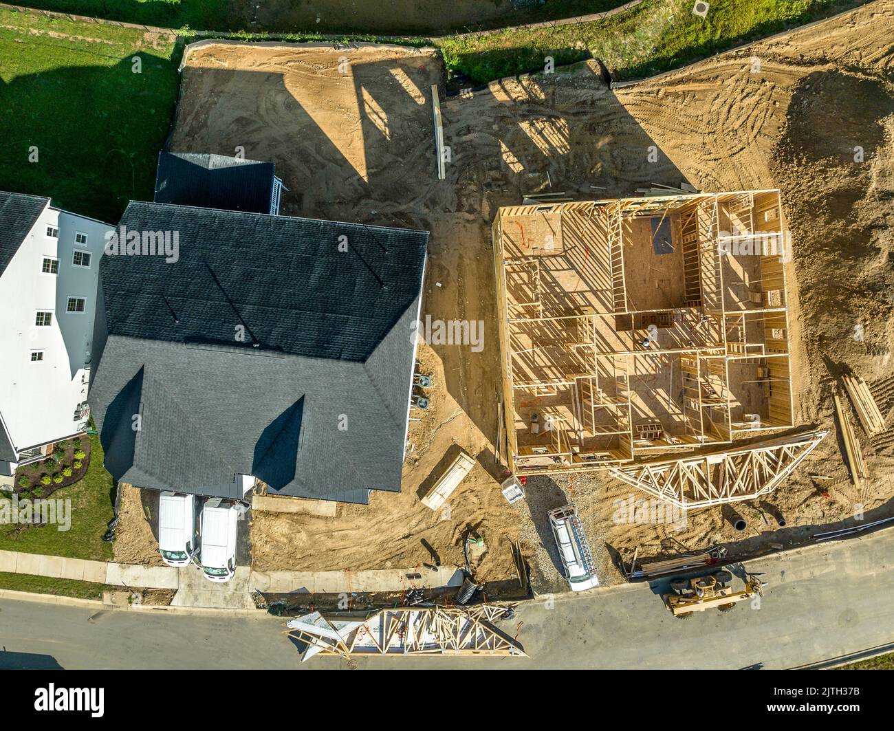 Wooden formwork of an unfinished house next to a move in ready home Stock Photo