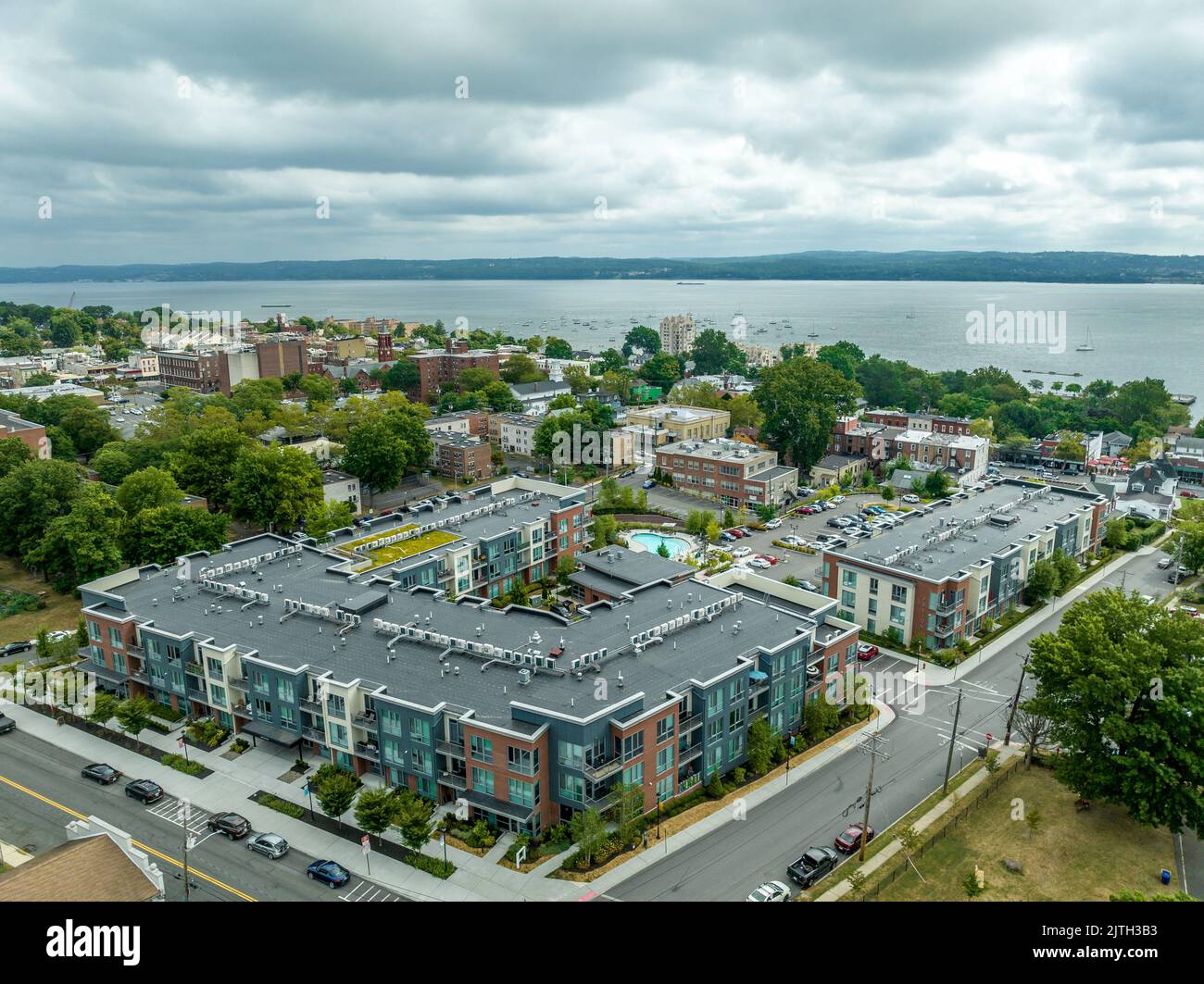 Aerial view of modern condo complex with colorful facade and swimming