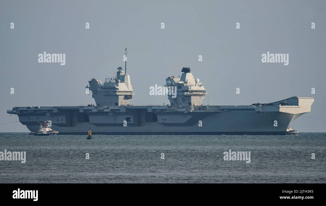 HMS Prince of Wales (R09) passing slowly through The Solent, UK to a safe anchorage at Stokes Bay on 29/8/2022 to investigate a propulsion defect. Stock Photo