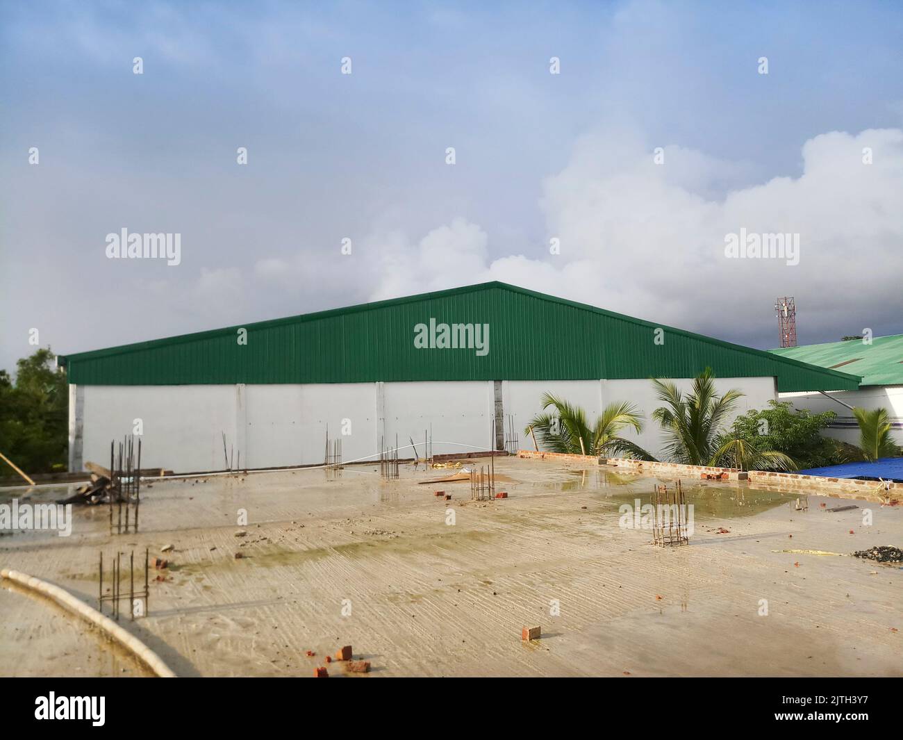 Kolkata, West Bengal, India - 29th July 2019 : Roof top of a factory with blue cloudy sky in background, Stock Photo