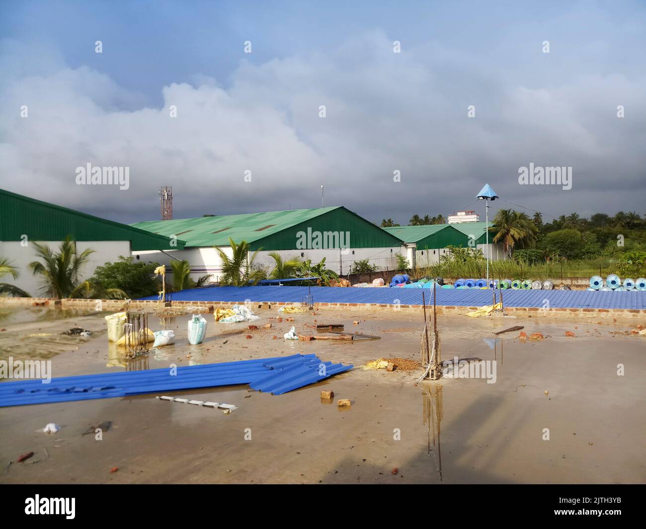 Kolkata, West Bengal, India - 29th July 2019 : Roof top of a factory with blue cloudy sky in background, Stock Photo