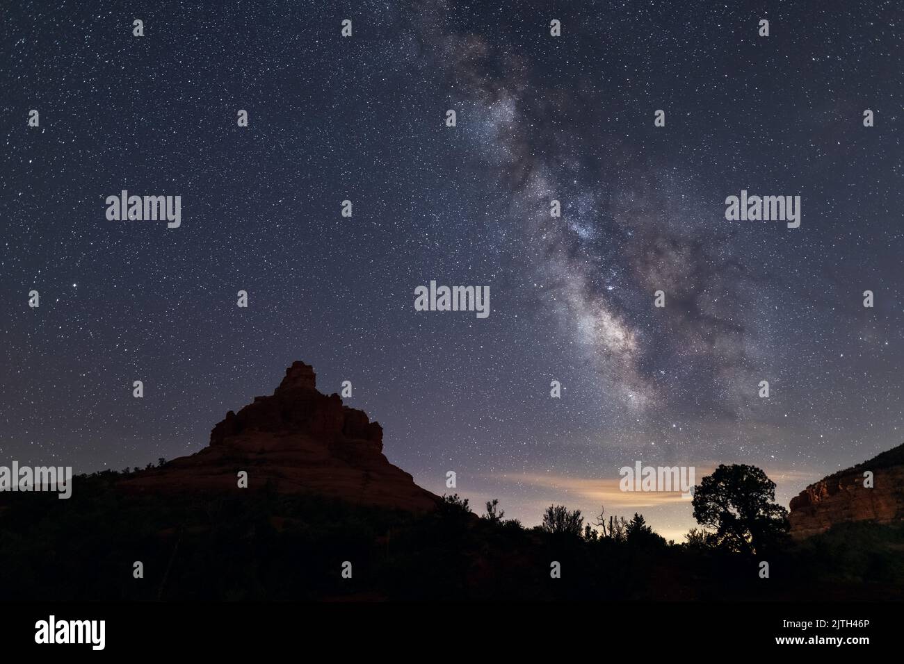 The Milky Way over Bell Rock in Sedona, Arizona Stock Photo