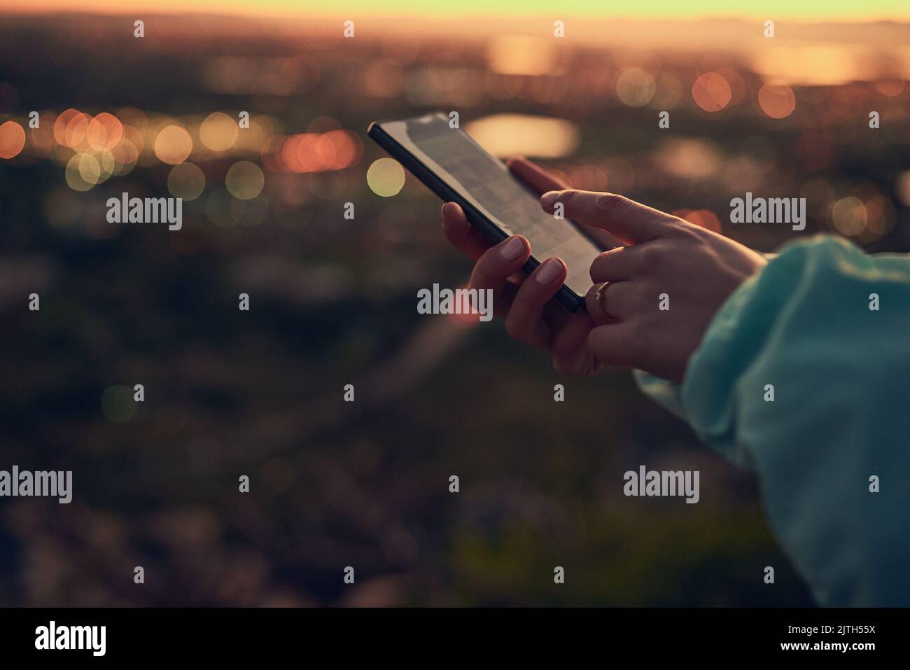 Status update On my way to the top. an unrecognizable woman sending a text message while standing on a lookout point. Stock Photo