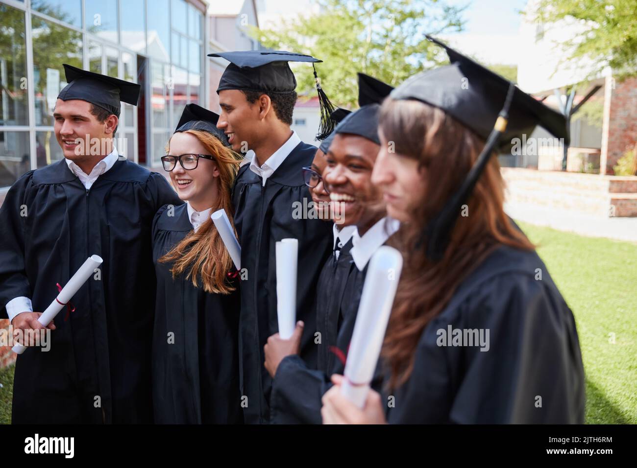 Posing for some graduations pics. a happy group of students standing