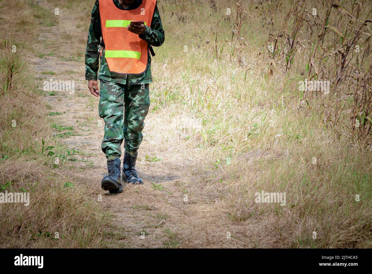 Reconnaissance infantry using cell phones in fields to send news to