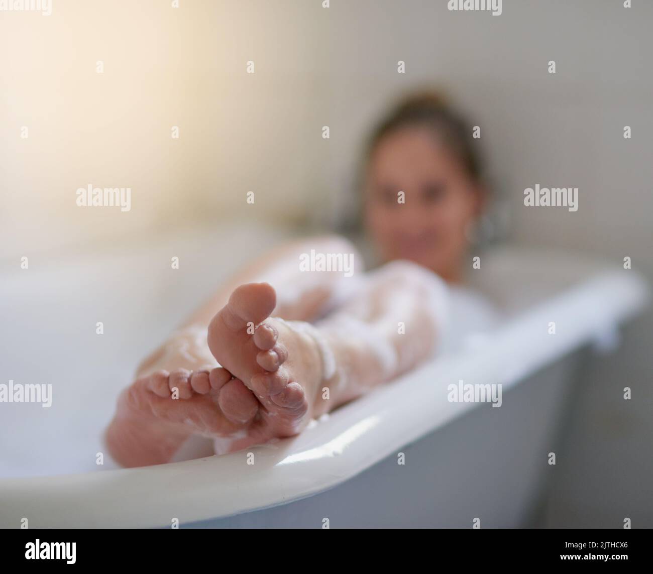 Lay back and relax. a beautiful young woman relaxing in the bathtub