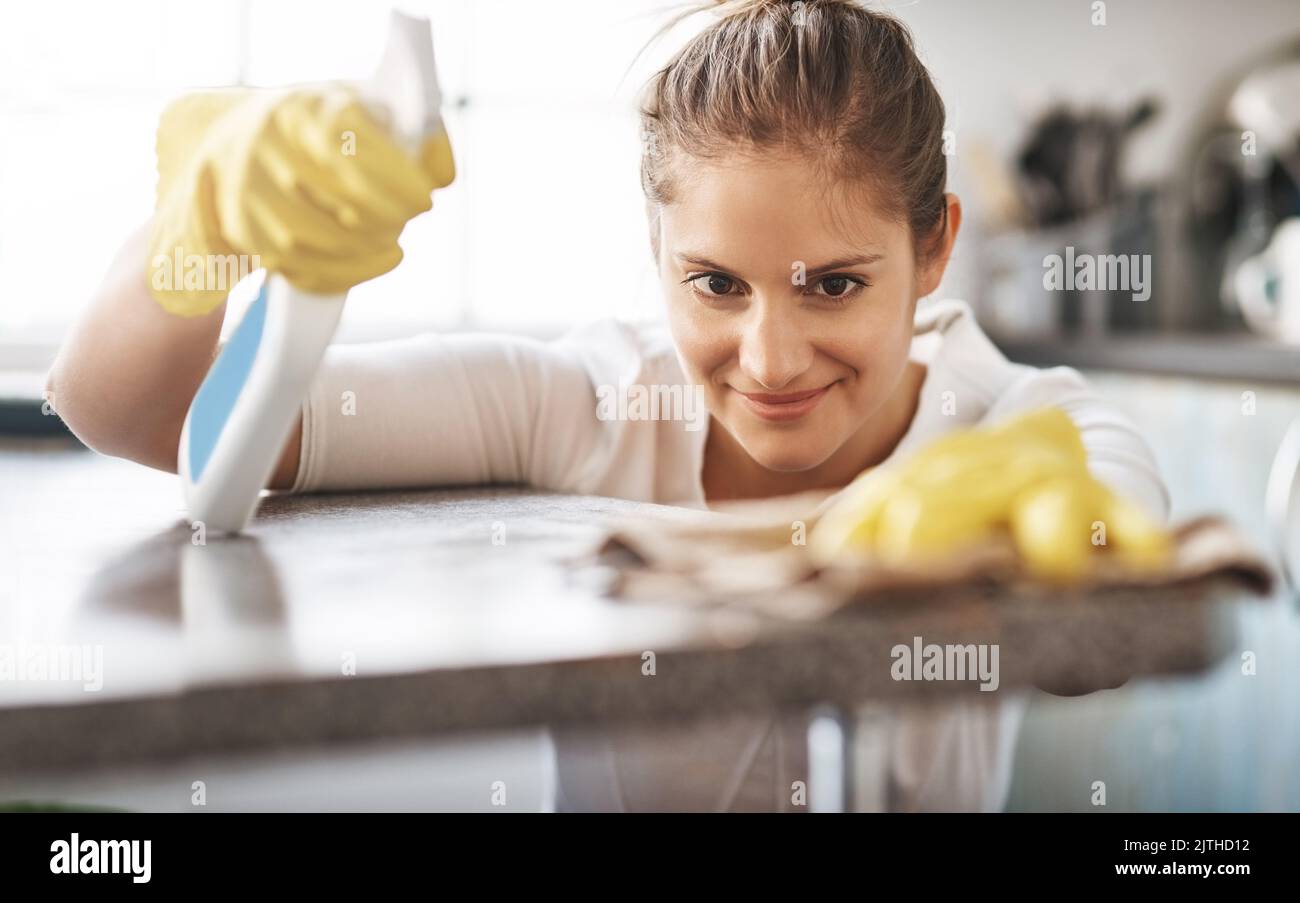 I prefer having my kitchen spotless. a young woman cleaning her home ...