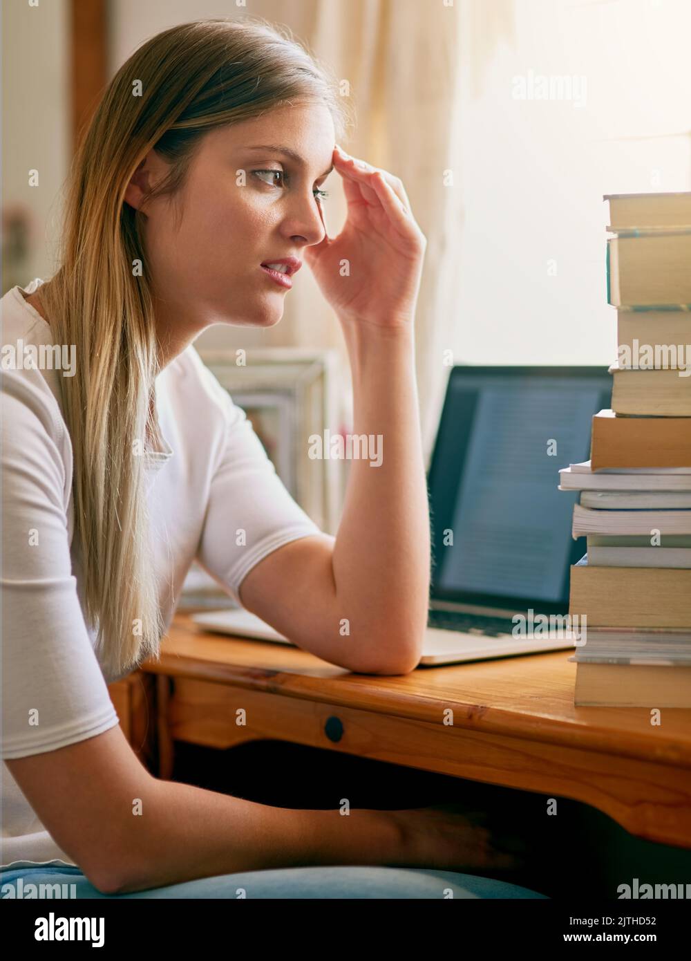 These books arent going to read themselves. a young woman looking ...