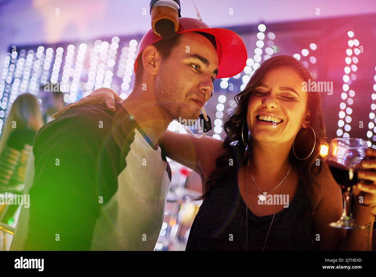 Drink triple, see double, act single. a young couple enjoying themselves at a nightclub. Stock Photo