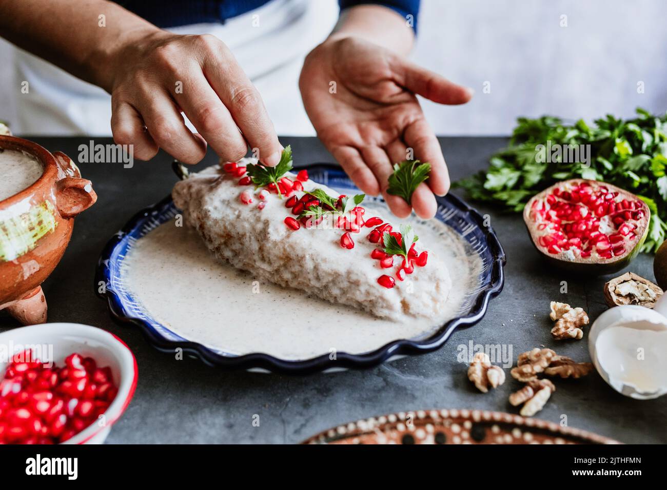 mexican woman cooking chiles en nogada recipe with Poblano chili and ...
