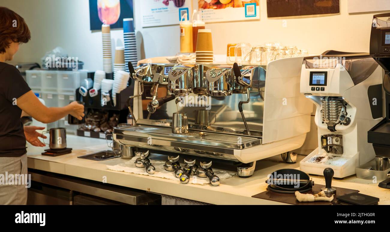 Barista working with coffee machine in coffee shop. Coffee maker for make espresso, americano