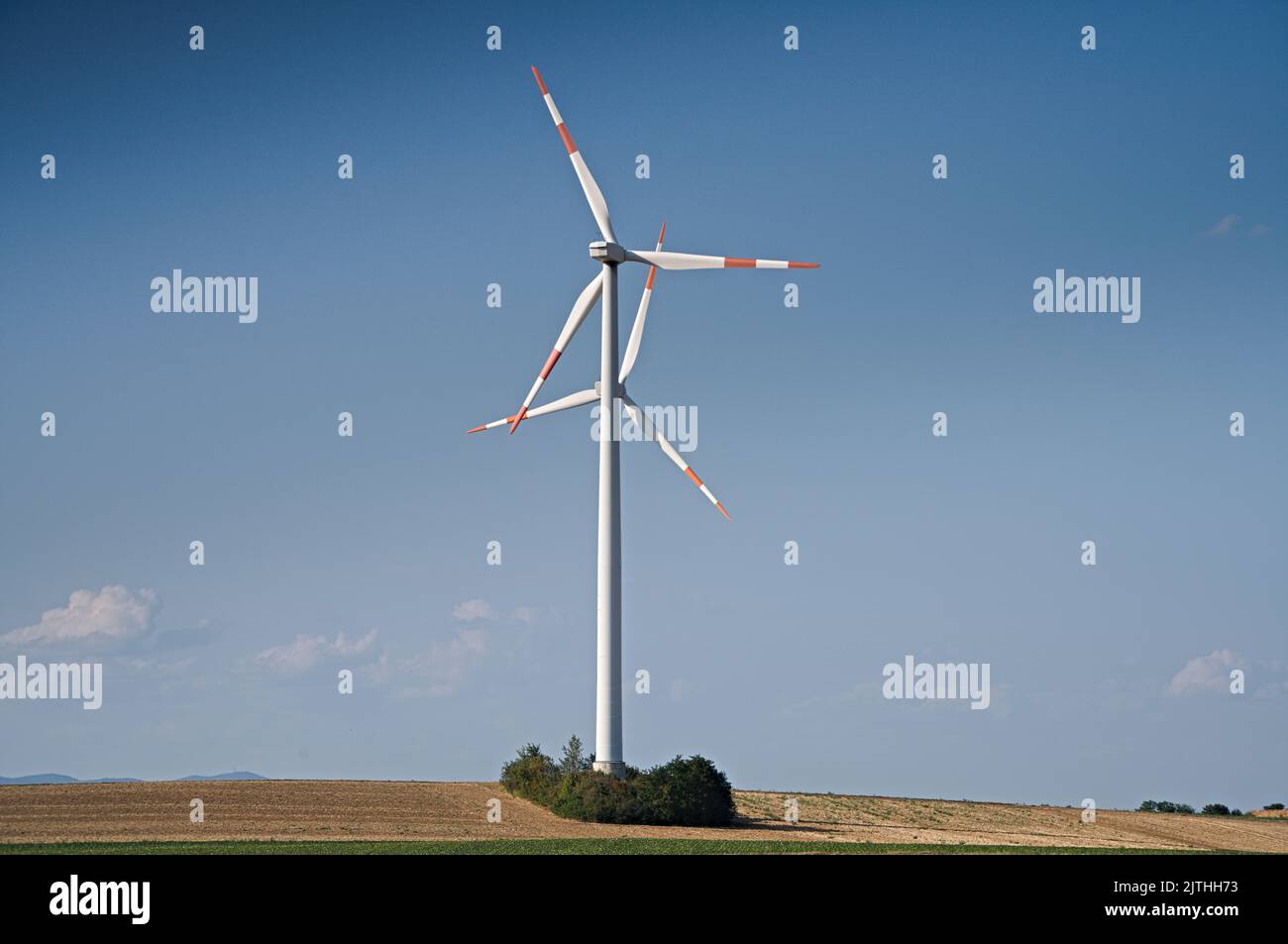 Two windturbines against blue sky Stock Photo