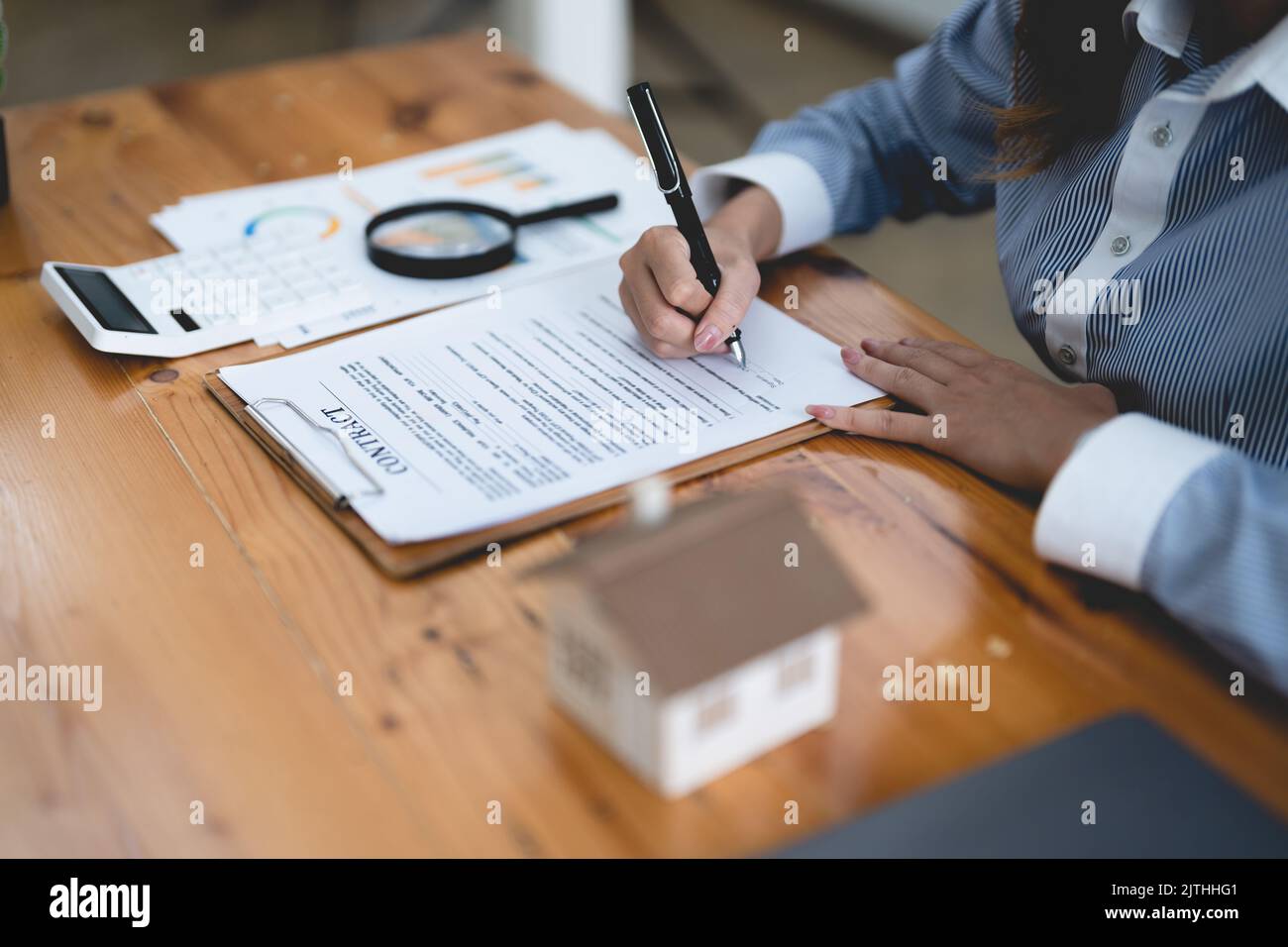 Woman signing rental contract at meeting with realtor or landlord, Property purchase, mortgage and loan ownership concept Stock Photo