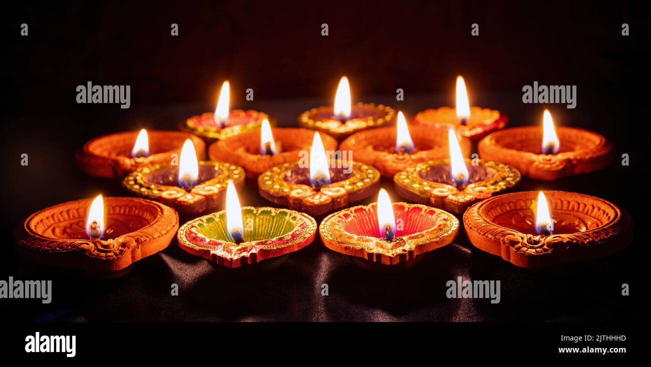 Diwali. Deepavali Hindu festival of lights. Clay diya candle. Oil lamp lit on dark background Stock Photo