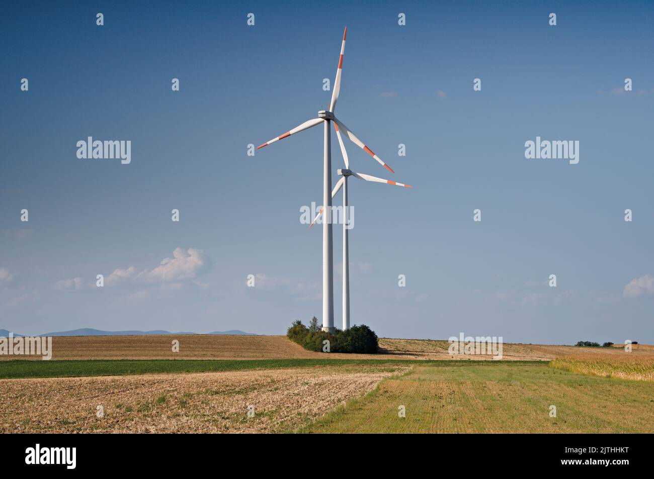 Two windturbines against blue sky Stock Photo