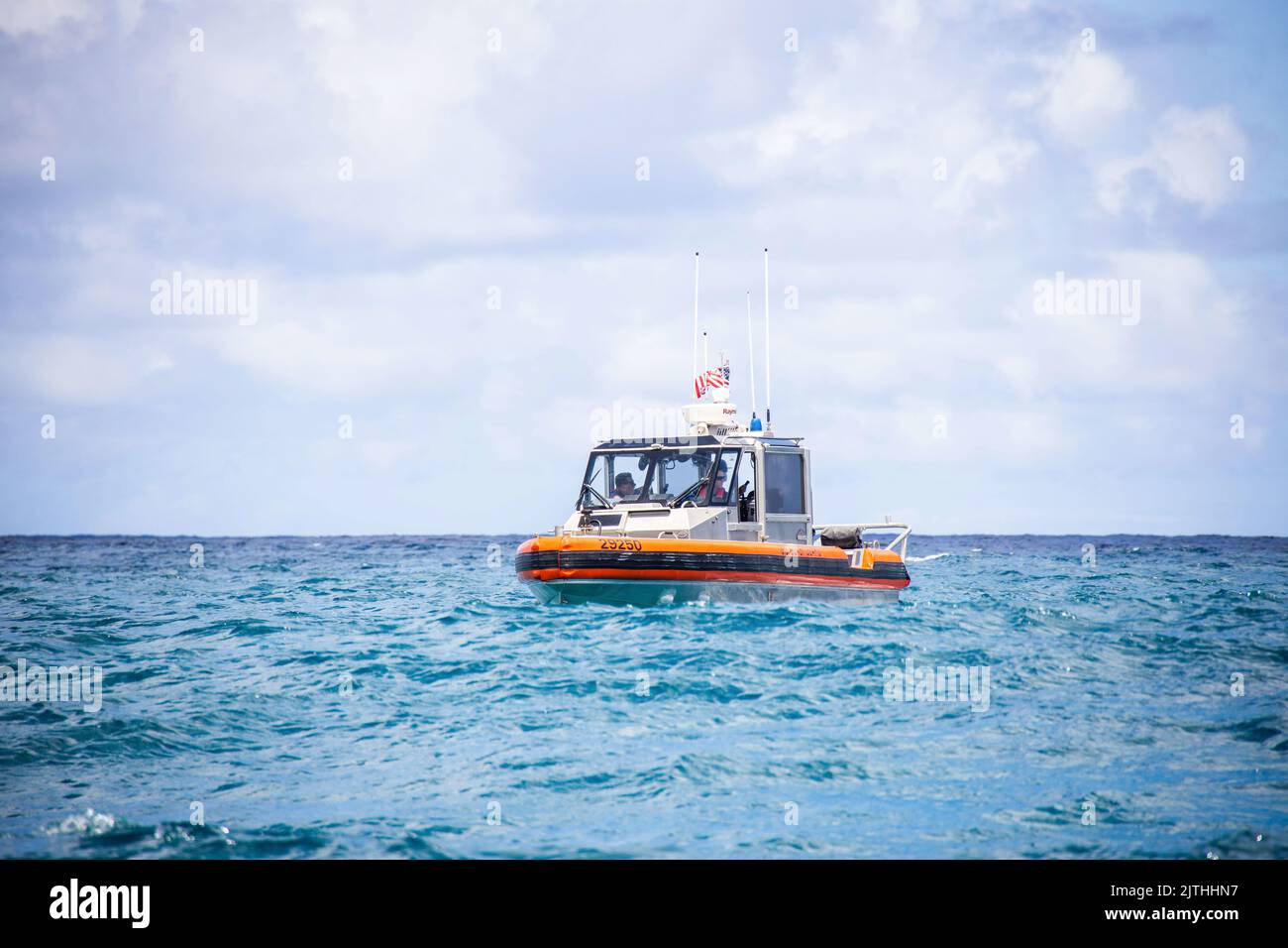 U.S. Coast Guardsmen aboard a rescue craft survey a search area while conducting a search and rescue exercise, Marine Corps Base Hawaii, Aug. 29, 2022. The exercise was conducted in order to increase readiness and interoperability between the U.S. Marine Corps, Navy, Coast Guard, Marine Corps Community Services and the Honolulu Fire Department, in response to emergency situations at sea. (U.S. Marine Corps photo by Cpl. Brandon Aultman) Stock Photo