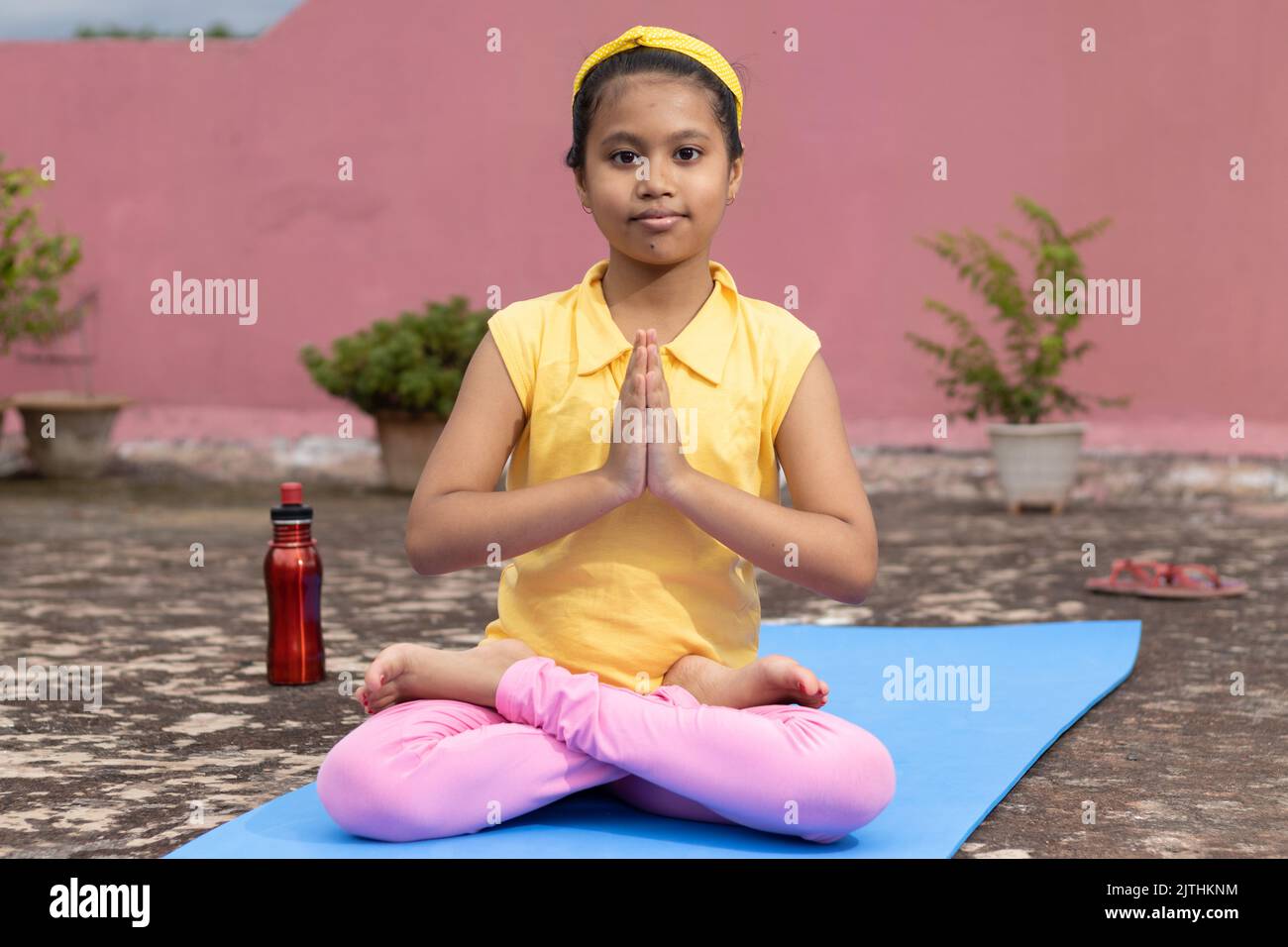 An Indian girl child practicing yoga on yoga mat outdoors Stock Photo -  Alamy