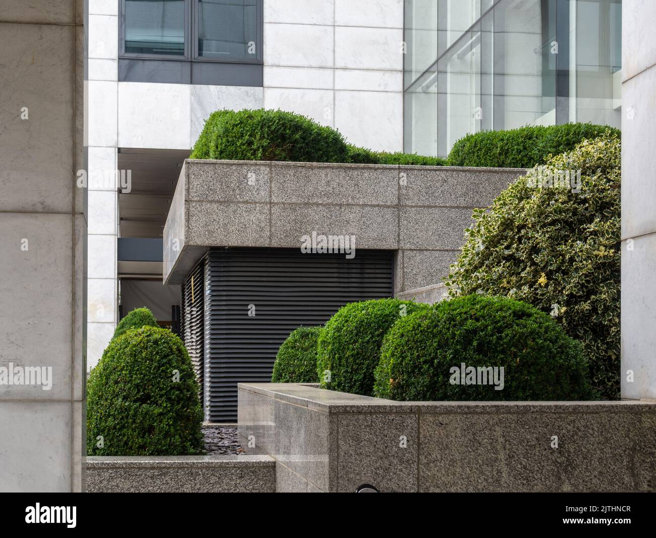 The angular lines of modern architecture softened by green planting, CBX House, Milton Keynes, UK Stock Photo