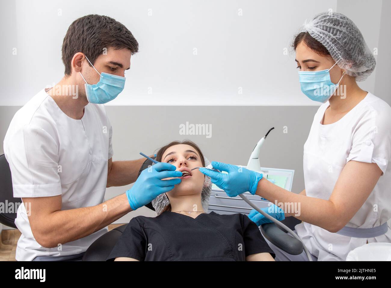 Group of students in dental clinic learn watching dental treatment with