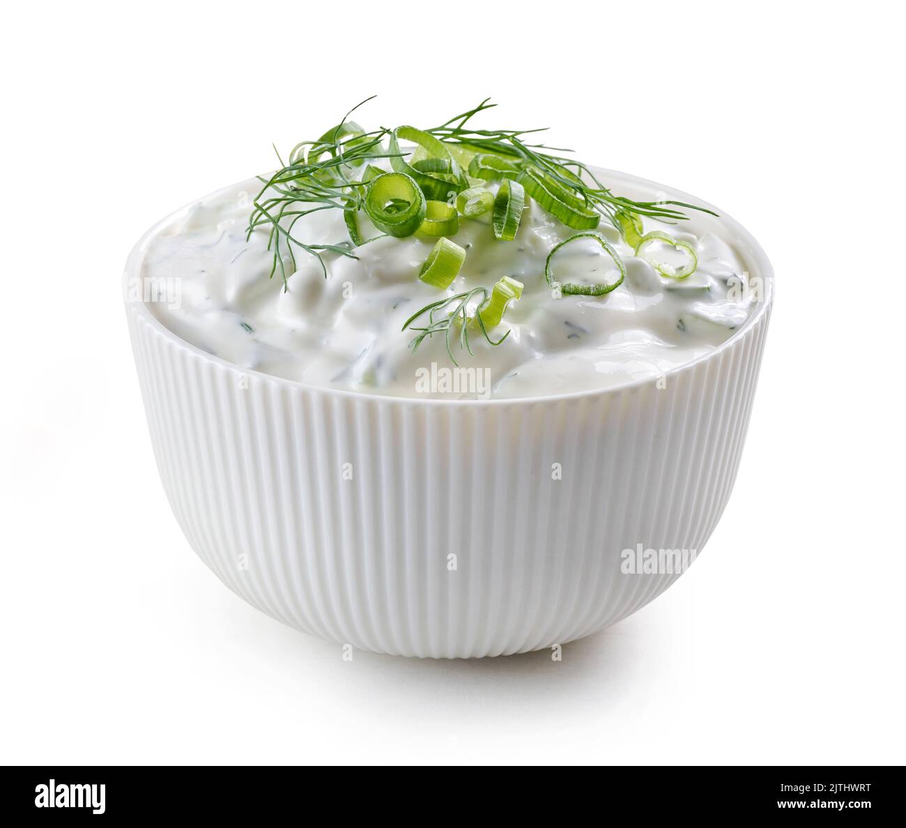 bowl of sour cream or greek yogurt tzatziki sauce isolated on white