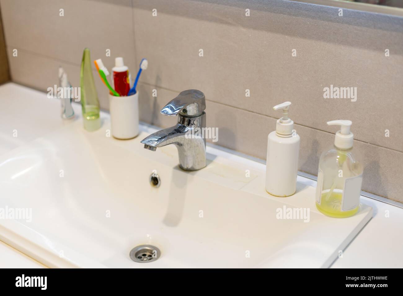 Old dirty washbasin with rust stains, limescale and soap stains in the