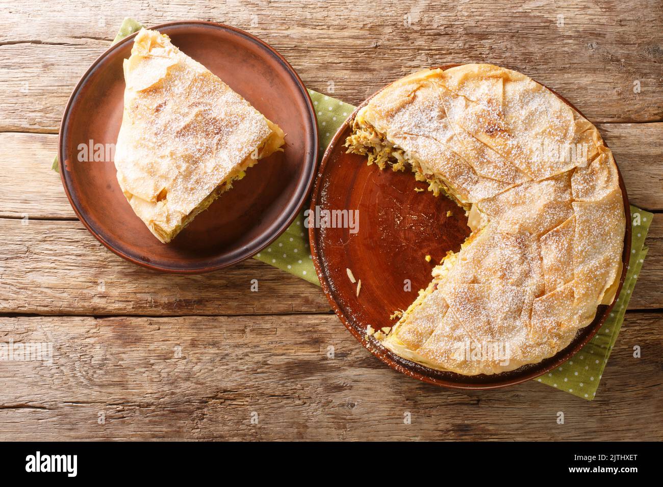 Chicken Bastilla pastilla shredded chicken with aromatic spices wrapped in perfectly crisp pastry layers closeup in the plate on the table. Horizontal Stock Photo