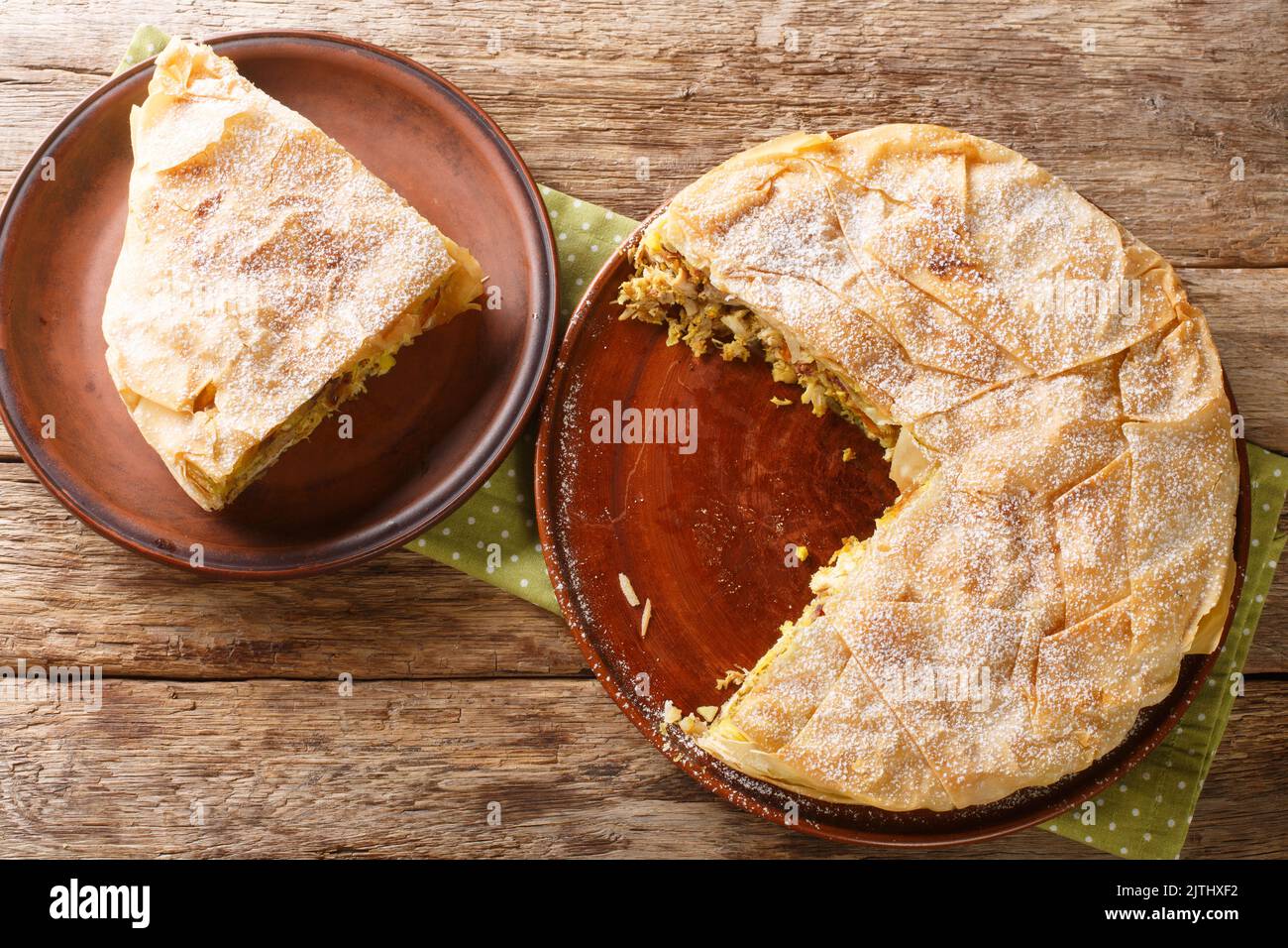 Piece Chicken Bastilla pastilla Moroccan pie closeup in the plate on the table. Horizontal top view from above Stock Photo