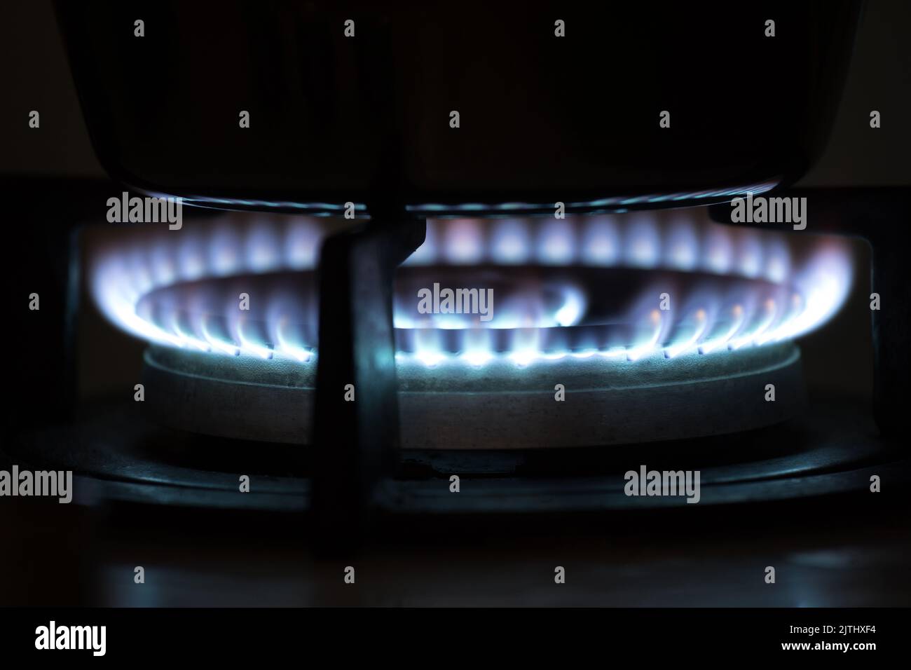 gas flames from a gas stove in the dark Stock Photo