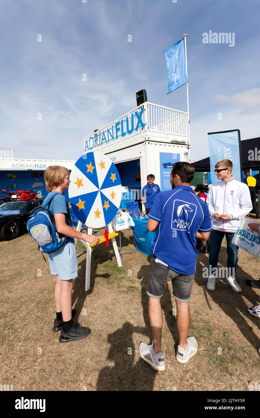 Adrian Flux running a competition at their stand, at the Village Green, during the 2022 Silverstone Classic Stock Photo