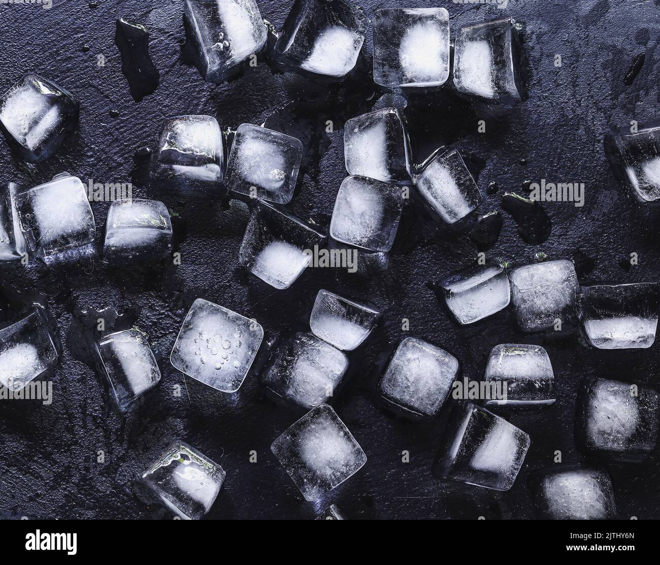 Ice cubes on a dark concrete background. Copy space. Top view
