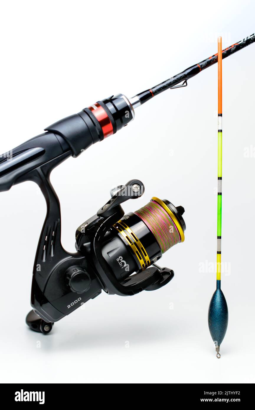 Fishing rod with a reel and float on a white background. Stock Photo