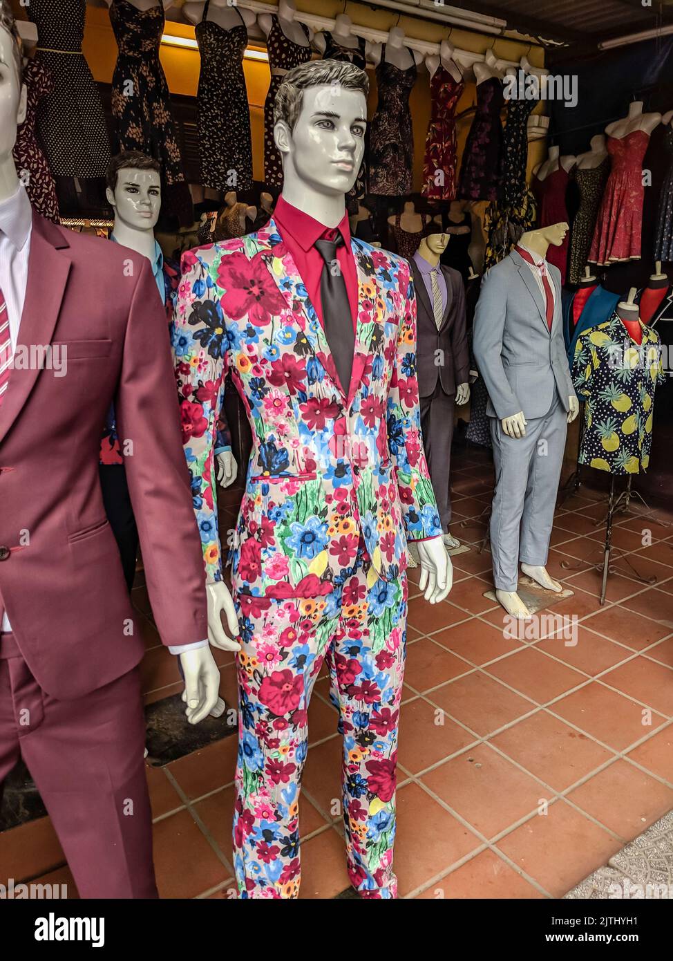 Flamboyant floral patterned suit at a tailors shop in Hoi An, Vietnam Stock Photo